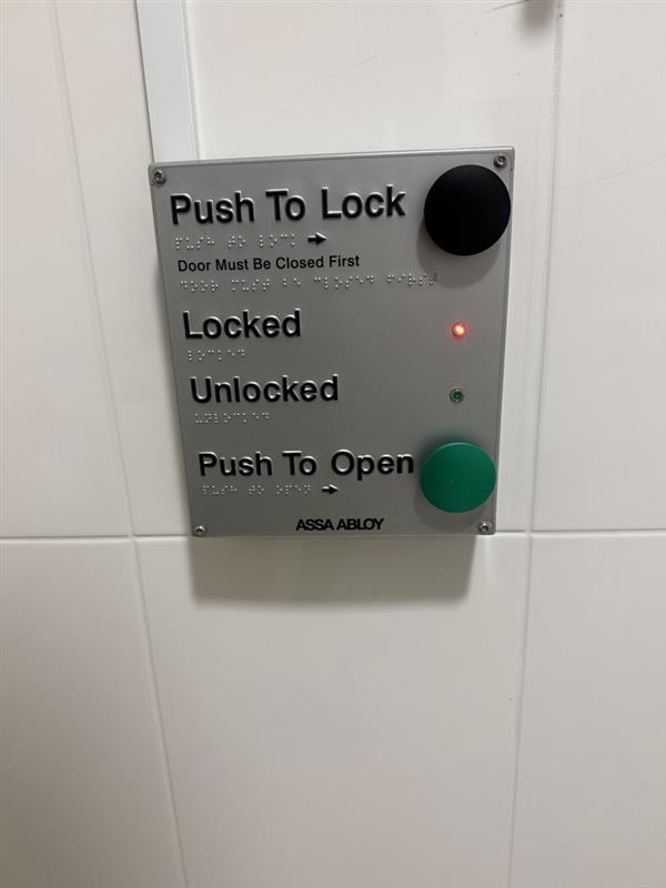 Braille push-to-lock and push-to-open accessible door control panel
